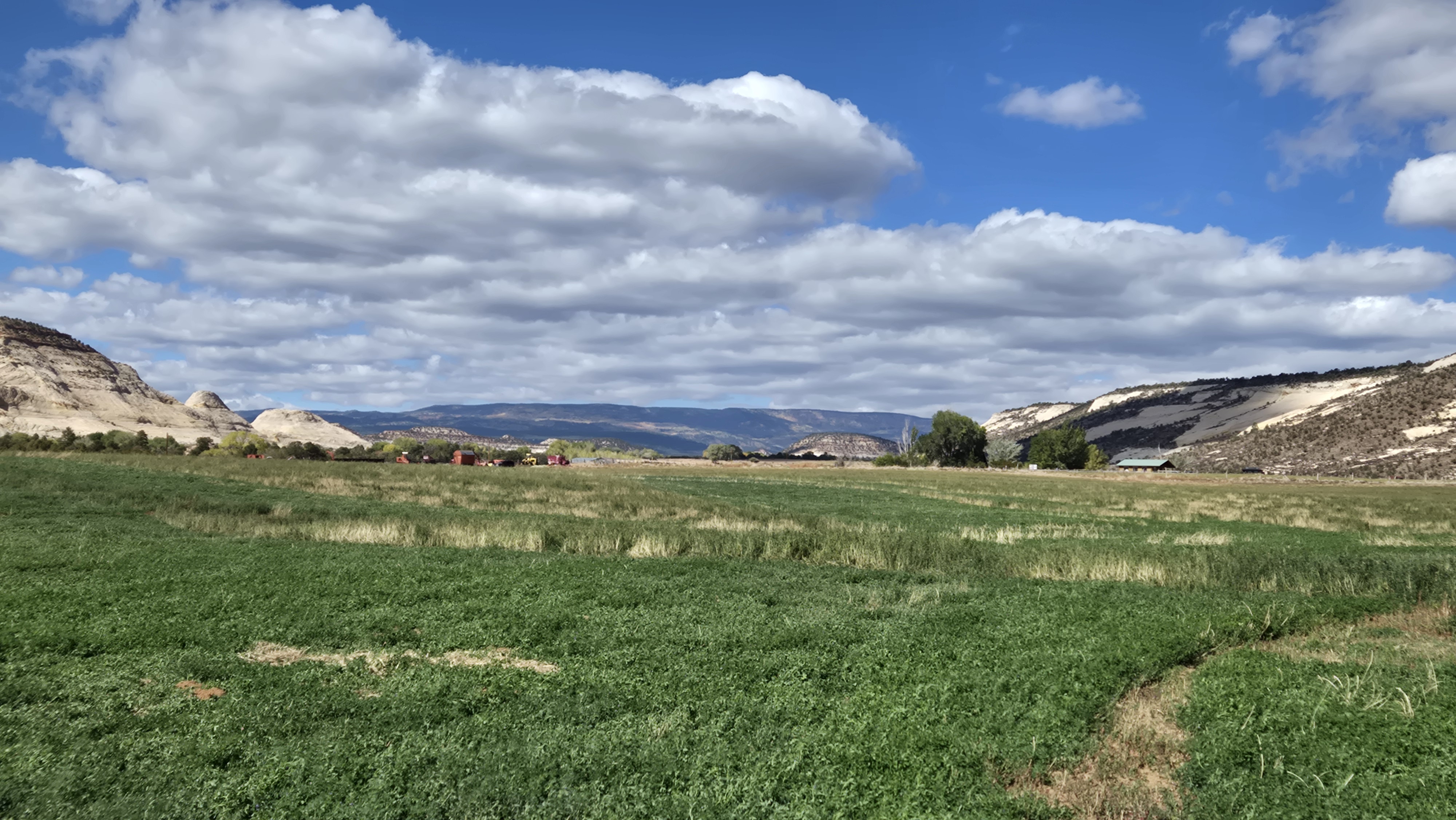 Open farm land and sandstone near Helaman Hills outside Boulder, Utah